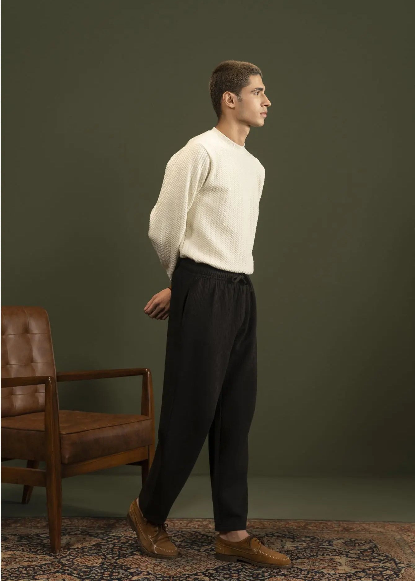 Men's black pull-on winter trousers, side view with relaxed, slightly tapered legs