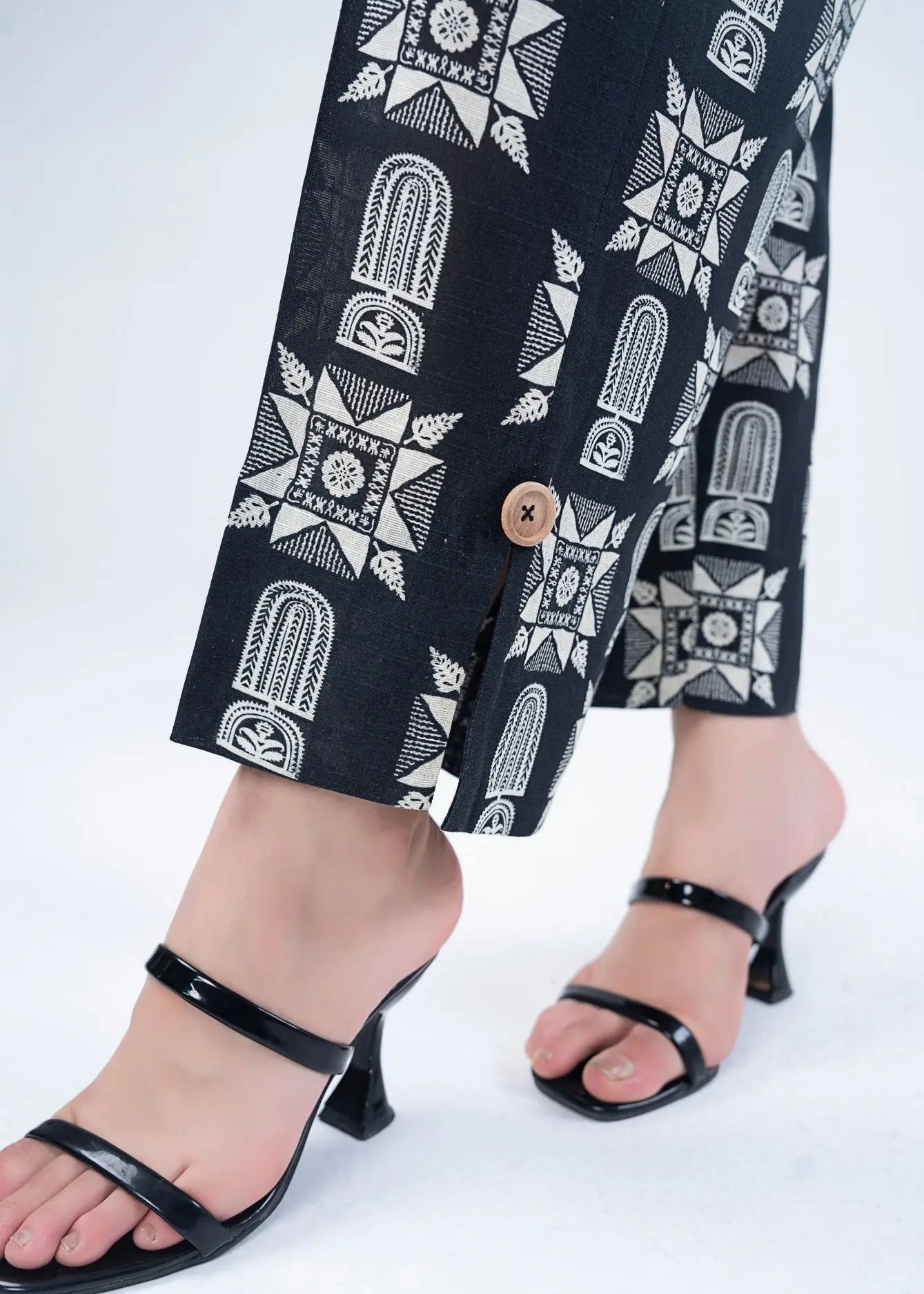 Wide-leg pants from the women’s co-ord set, black with white geometric print and button detail