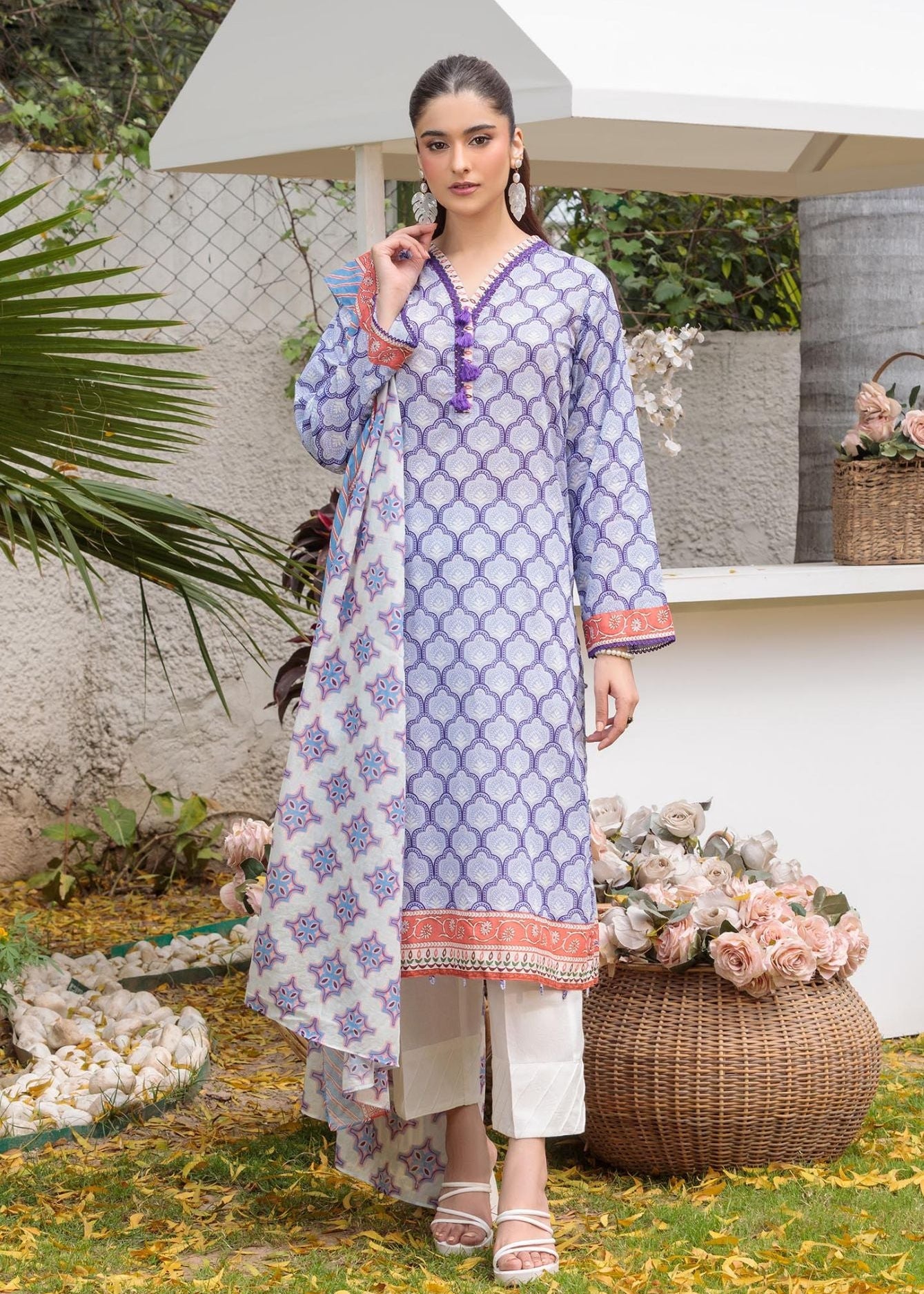 Lilac printed tunic with orange-and-blue trim, worn with white cropped pants