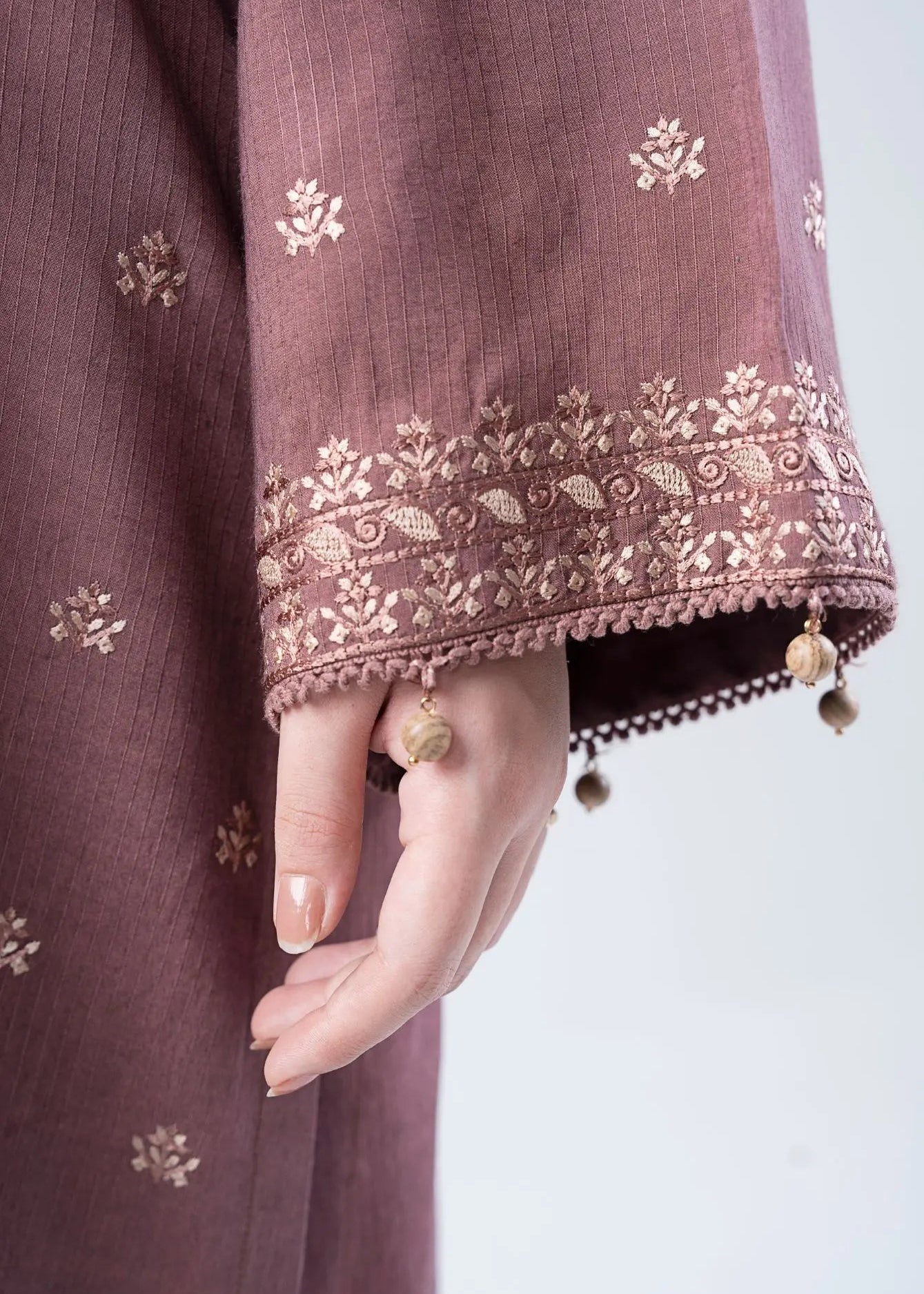Embroidered tunic sleeve detail with lace trim and dangling tassel trim