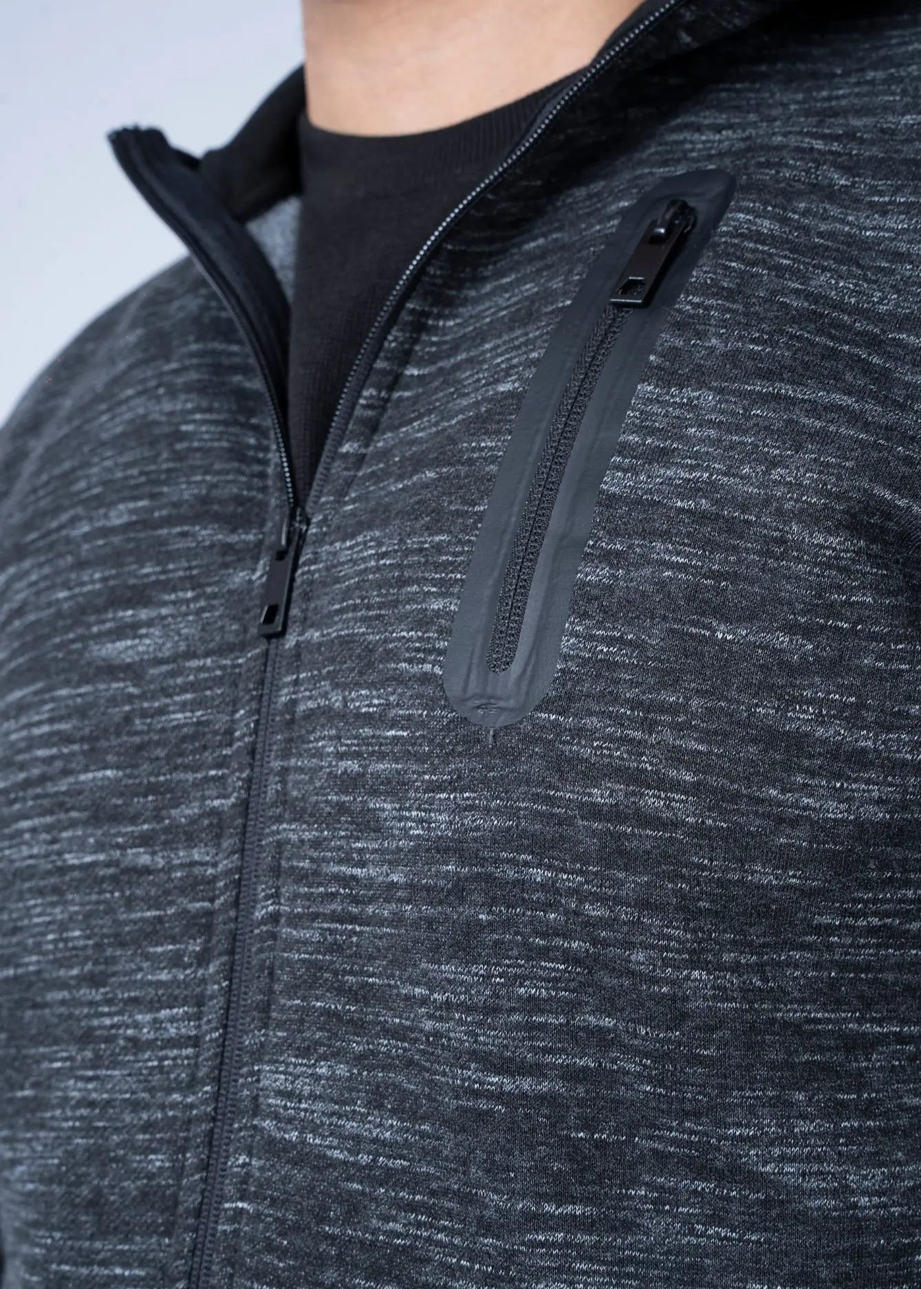 Close-up of dark heather fleece hoodie front zipper and stand-up collar