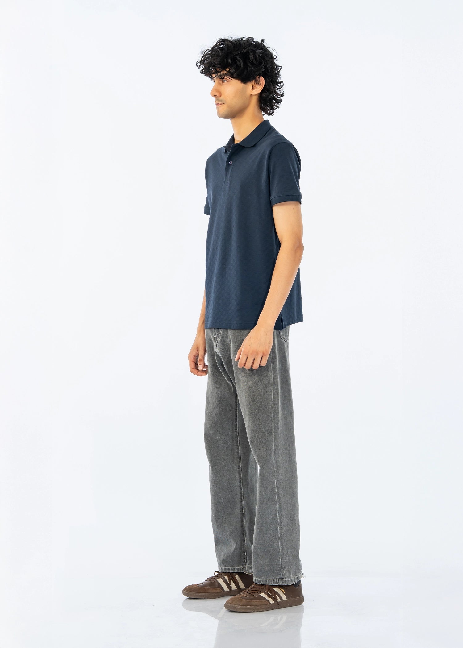 Men's dark polo shirt with short sleeves, side view showing collar and placket