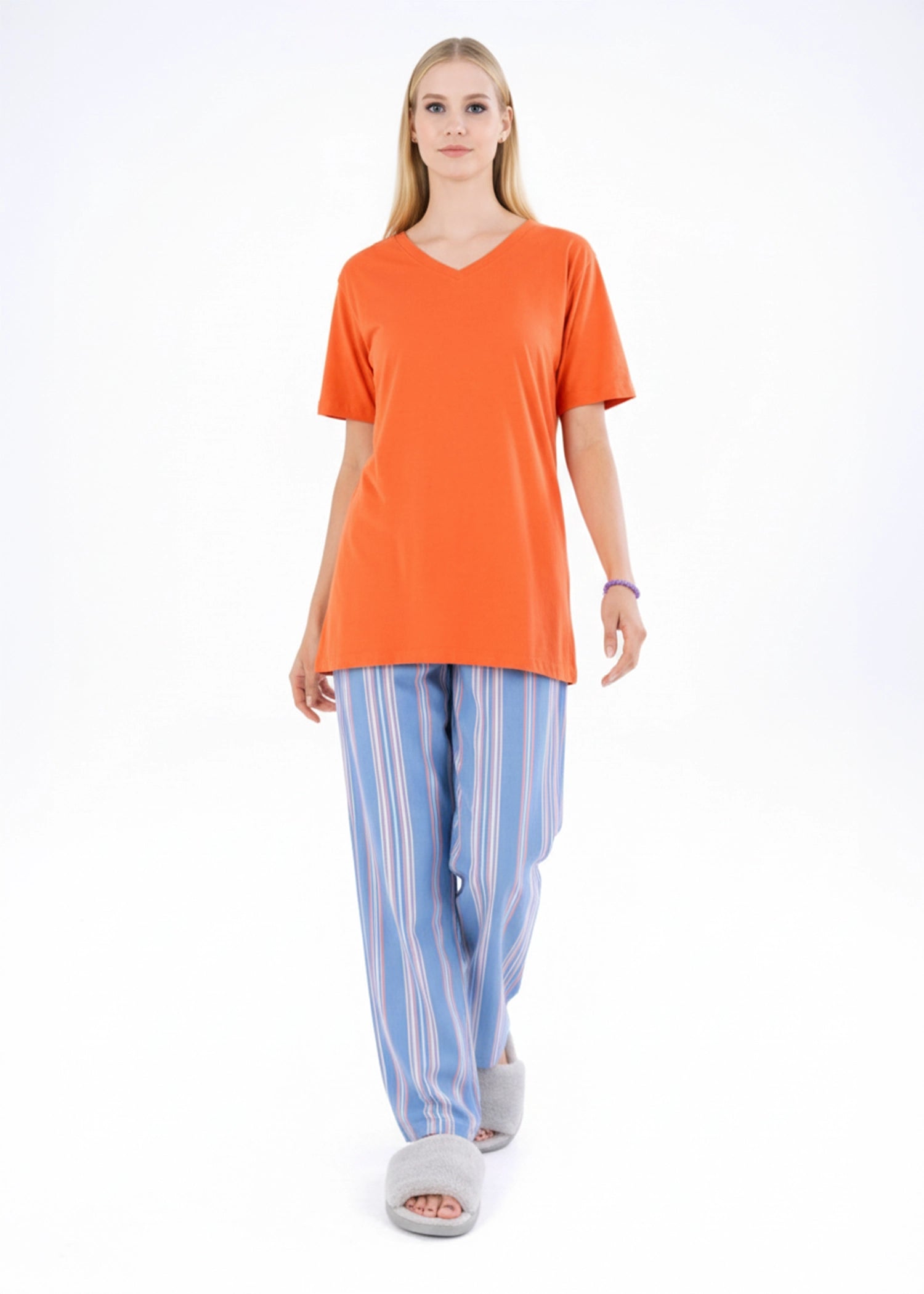 Women’s night suit with orange short-sleeve top and blue striped pajama pants, front view