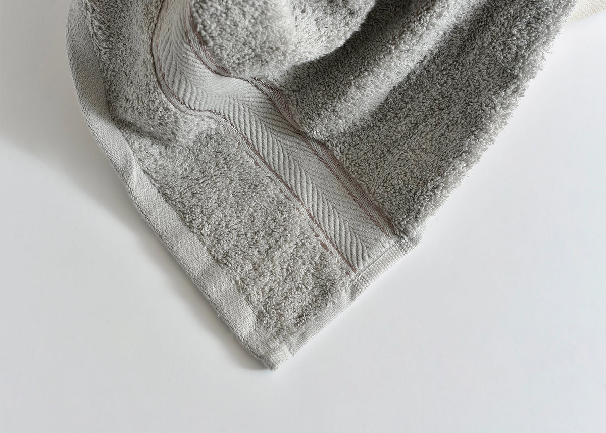 Light gray Pima cotton bath towel corner with stitched trim