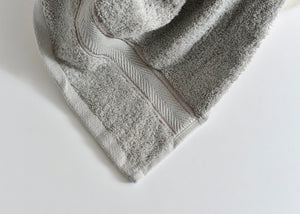 Light gray Pima cotton bath towel corner with stitched trim