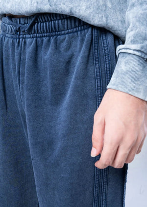 Men's navy terry pull-on trousers close-up: elastic waistband and side seam