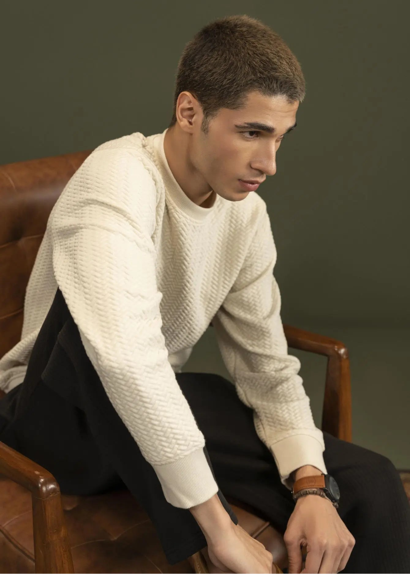 Stone jacquard knit sweatshirt with crewneck and ribbed cuffs, worn with dark pants