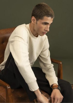Stone jacquard knit sweatshirt with crewneck and ribbed cuffs, worn with dark pants