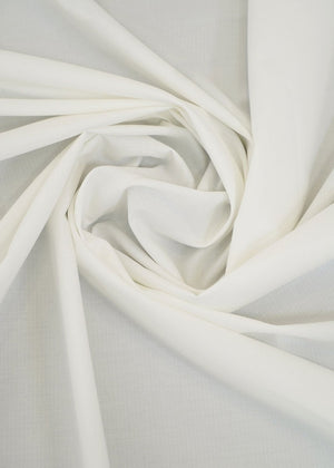 Off-white dobby fabric with woven texture, folded in soft folds
