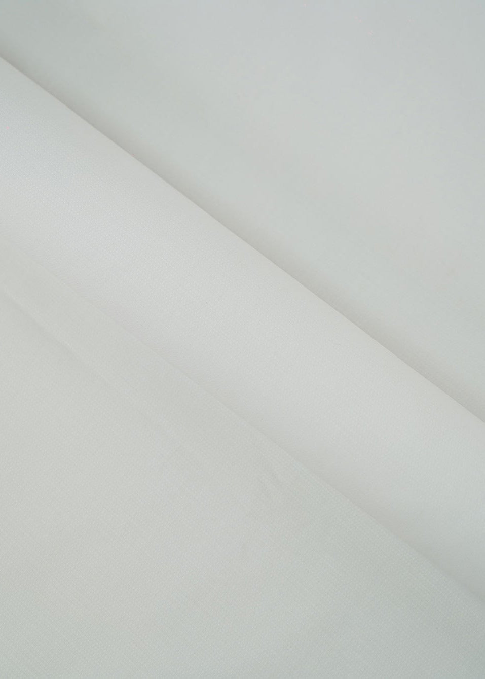 Off-white dobby fabric panel with subtle geometric weave, draped diagonally