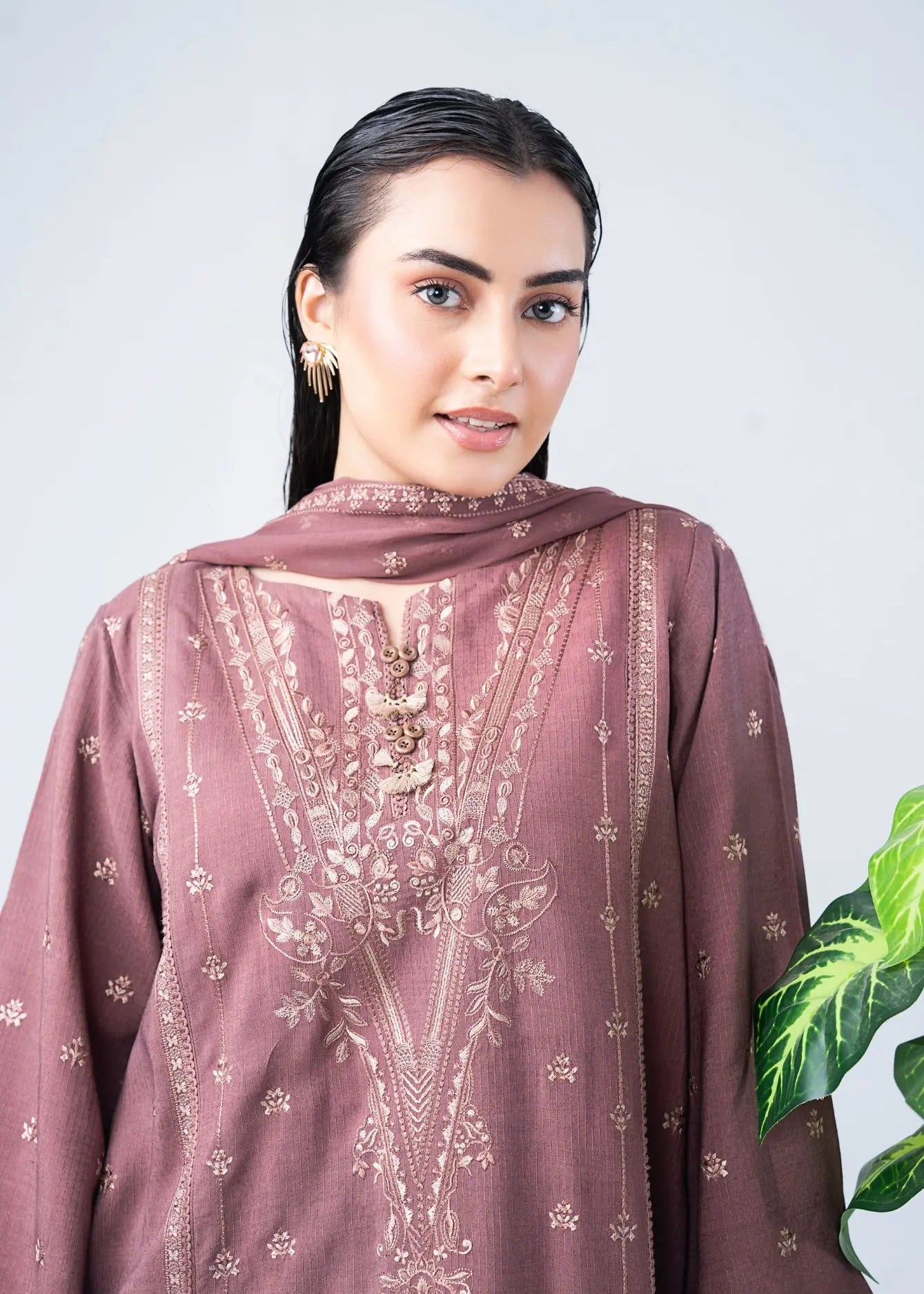 Close-up of women’s embroidered tunic neckline and front panel with gold details