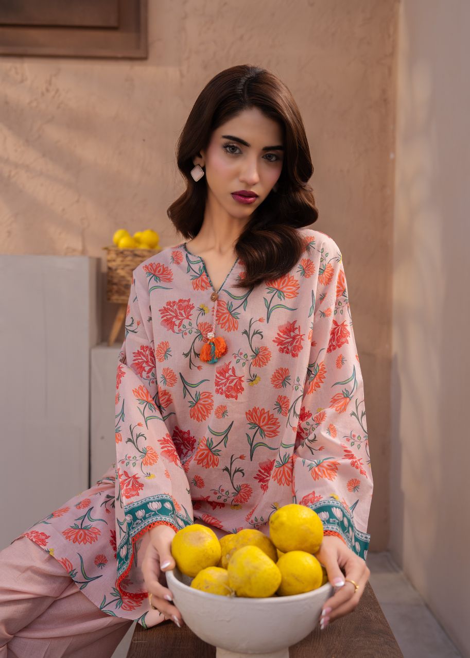Printed floral tunic top with orange and green motifs, blue border on sleeves