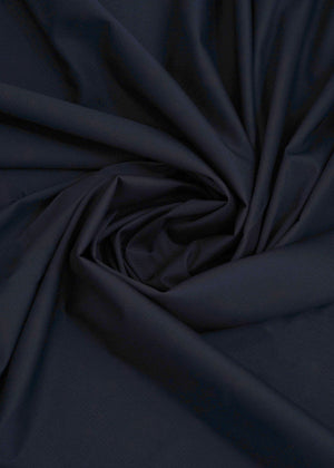 Navy blue dobby fabric with subtle woven texture, draped folds
