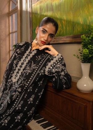 Dark printed tunic with bold white motifs and decorative neckline, long sleeves