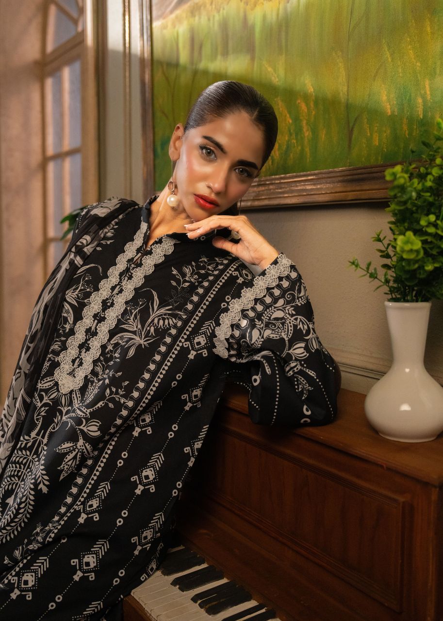 Dark printed tunic with bold white motifs and decorative neckline, long sleeves