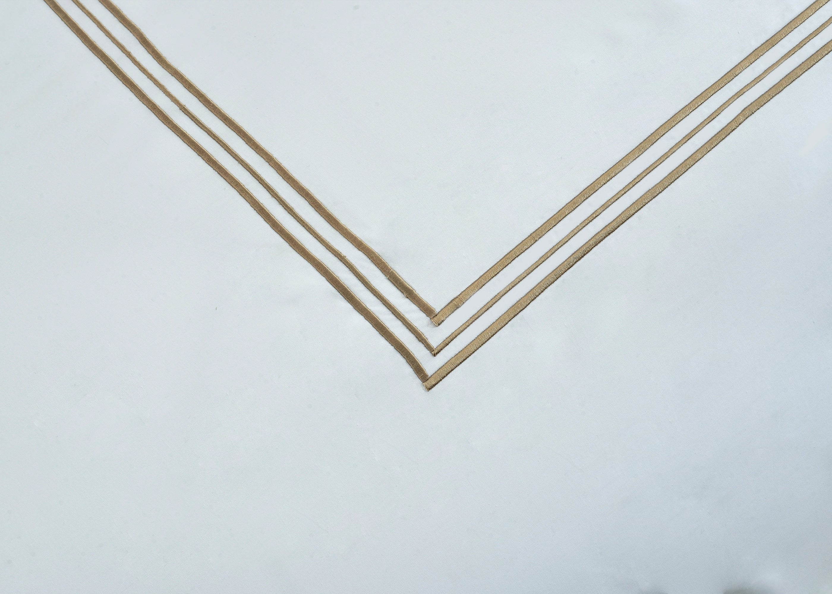 White pillowcase corner with gold double-stripe V border trim