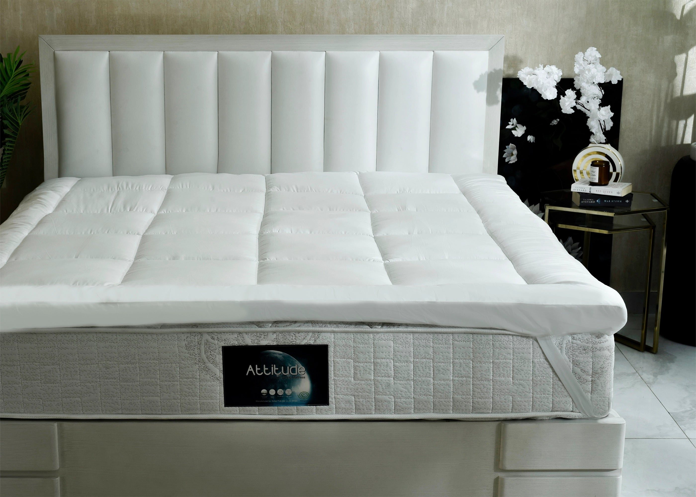 White quilted spring mattress with tufted panels and gray fabric base edge