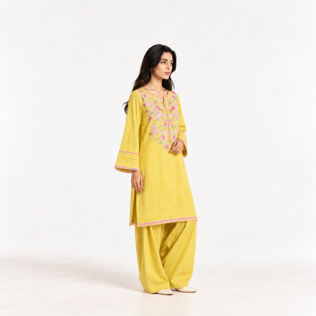 Mustard yellow embroidered two-piece suit, floral yoke kurta with pink trim and pants