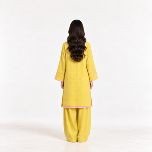 Mustard yellow embroidered two-piece suit, long kurta with pink trim and matching pants