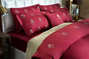Red floral comforter set with quilted pillows