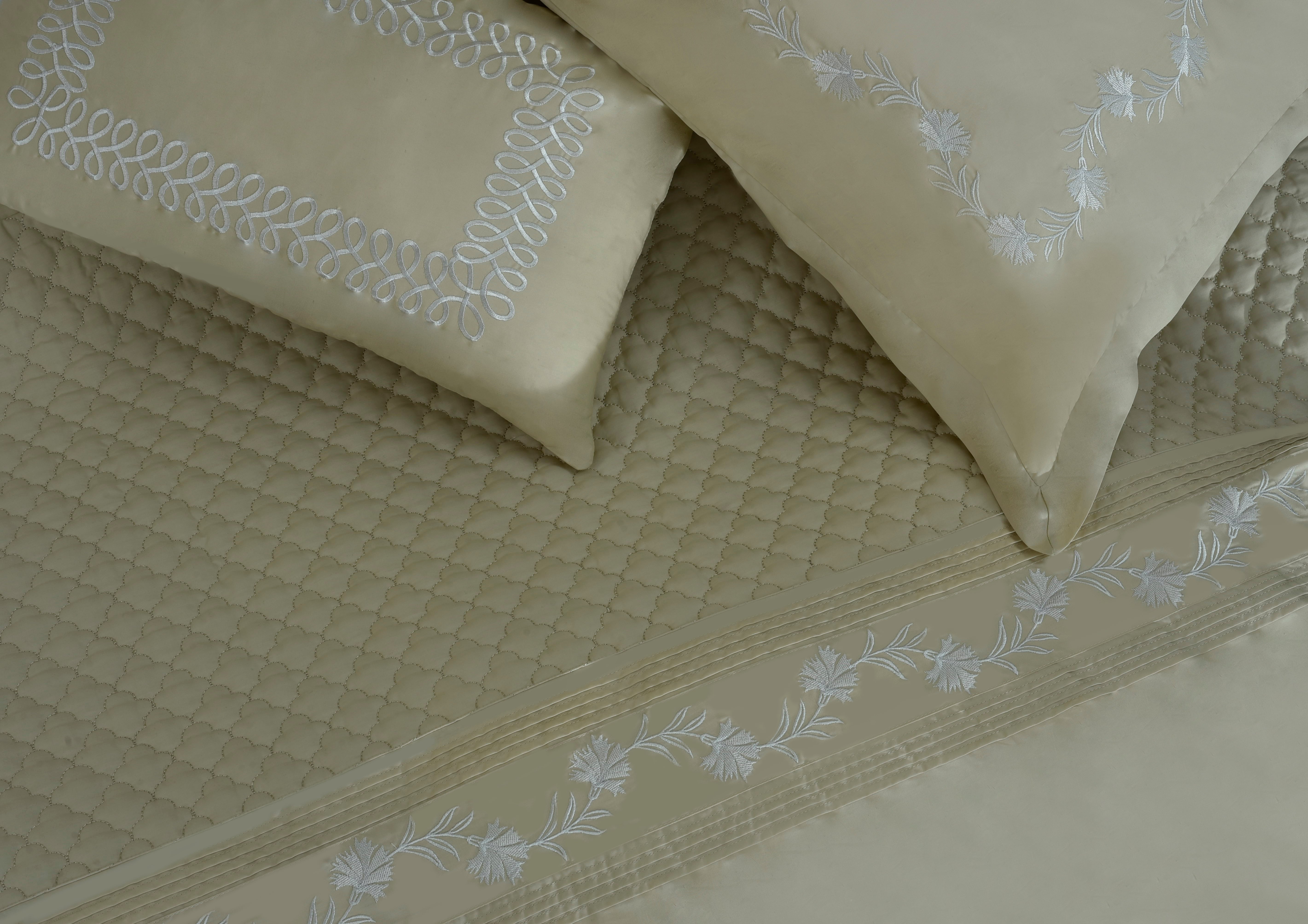 Sand quilted duvet with embroidered trim and textured pillow covers