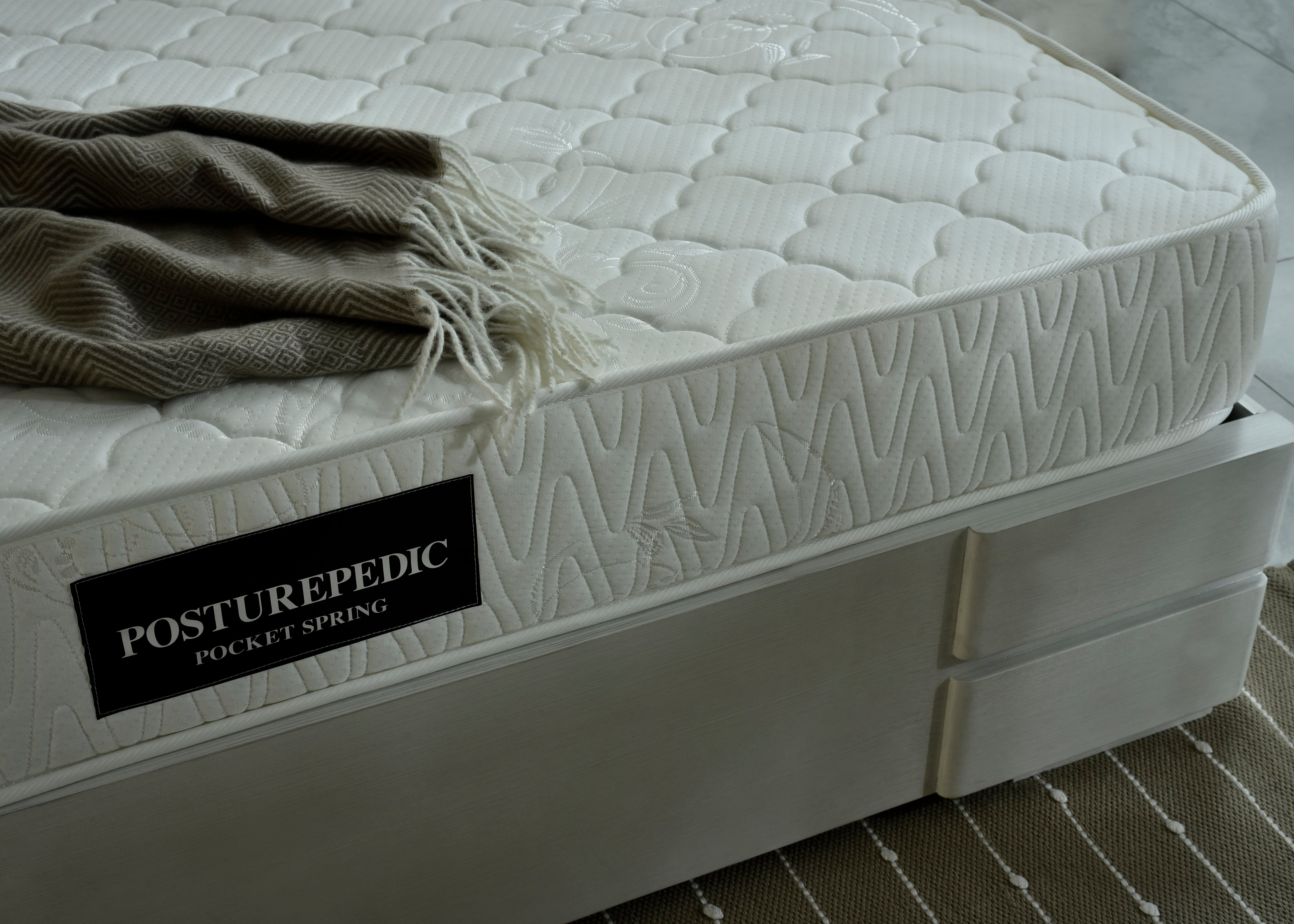White pocket spring mattress with side label and quilted surface detail