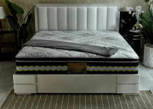 Eurotop spring mattress with white quilted cover and dark edge trim