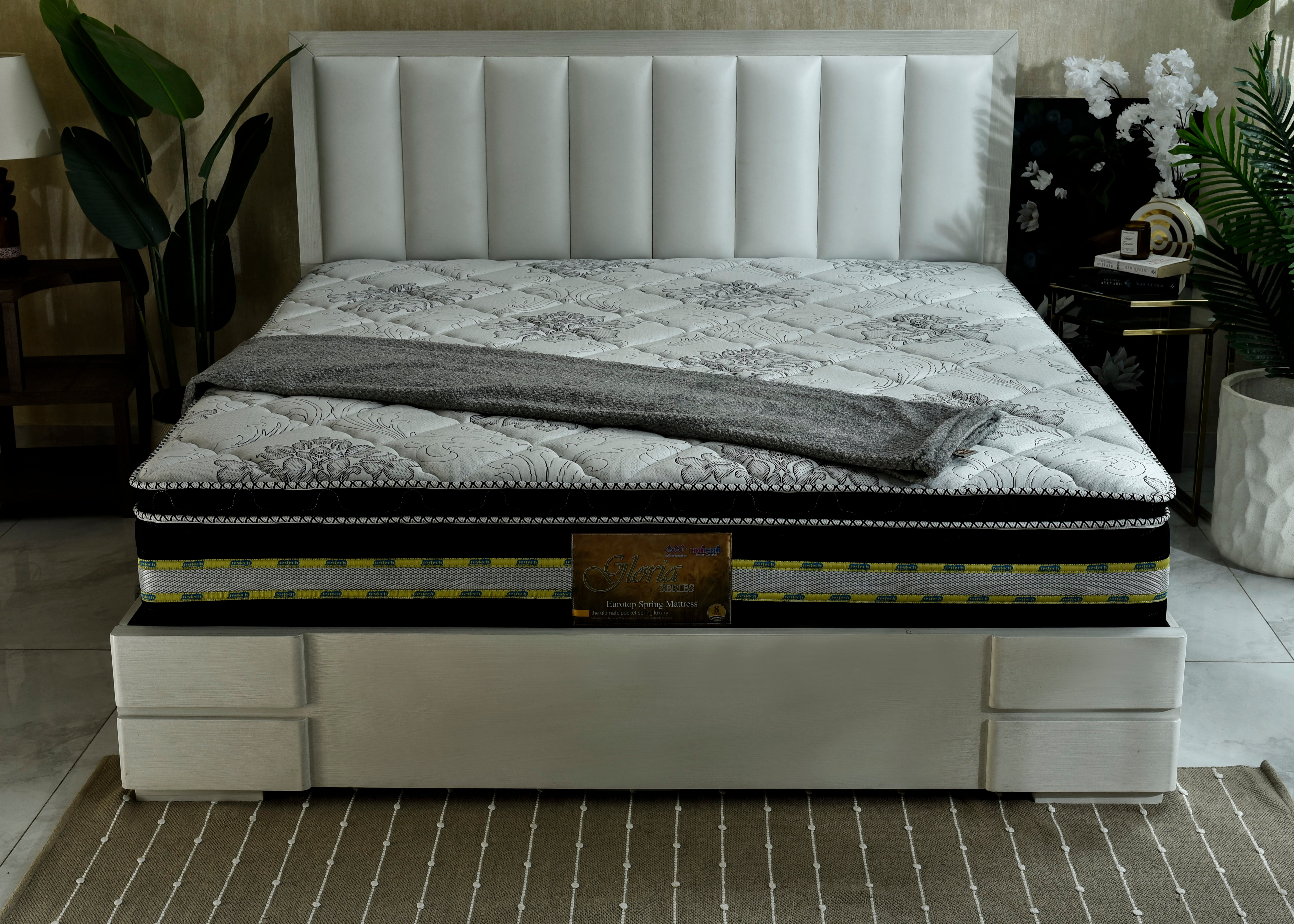 Eurotop spring mattress with white quilted cover and dark edge trim