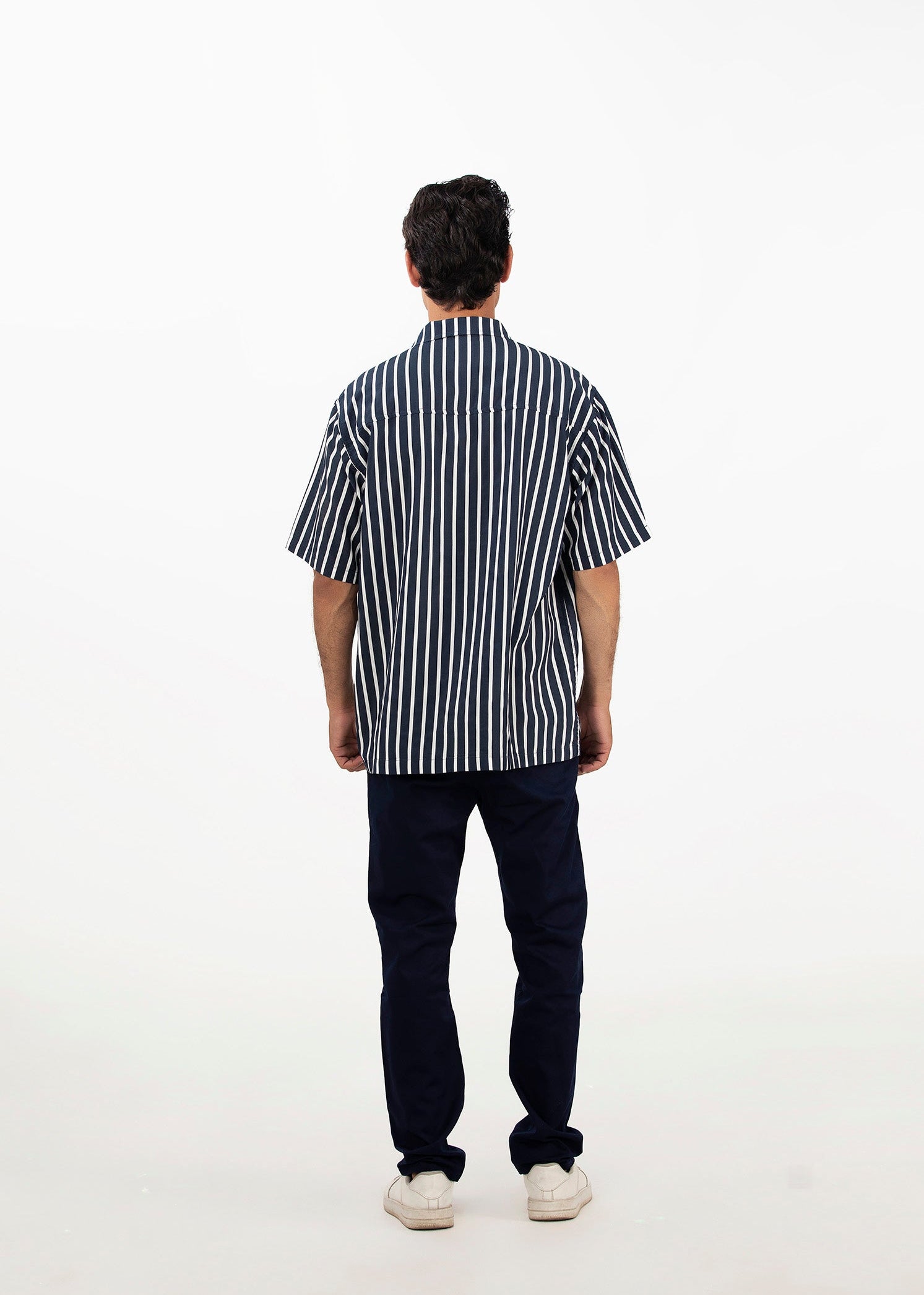 Men's striped short-sleeve button-up shirt with dark vertical stripes, back view
