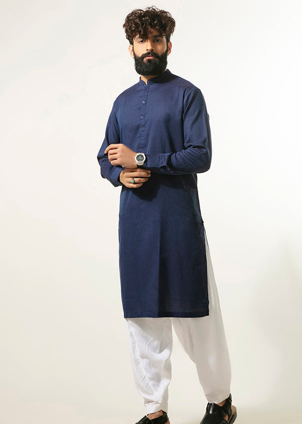 Blue long kurta tunic with stand collar and button front, paired with white pants