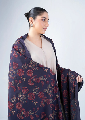 Women's wool winter shawl in dark navy with burgundy floral pattern, draped on shoulders