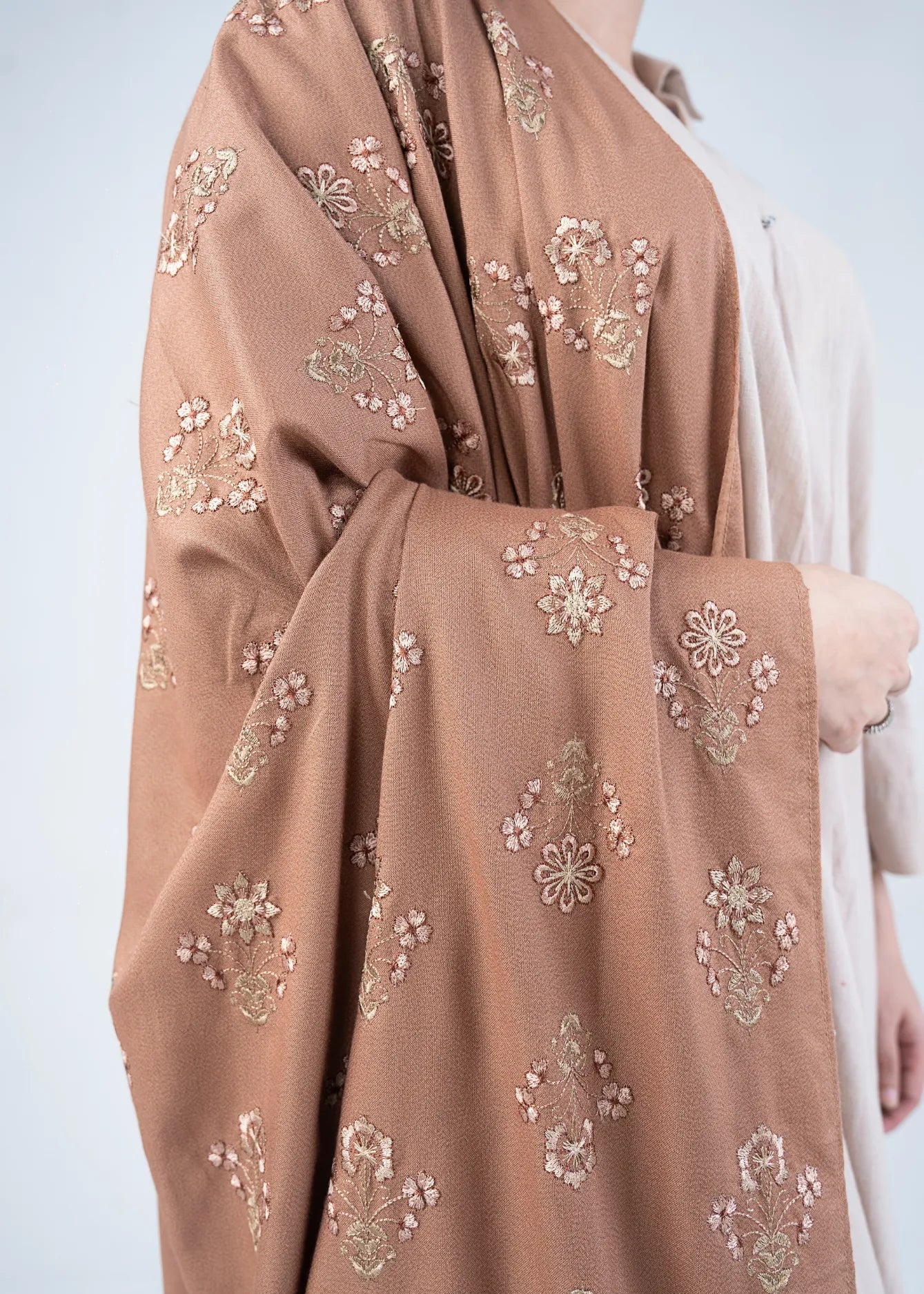 Women's brown wool winter shawl, floral embroidery, draped over shoulder