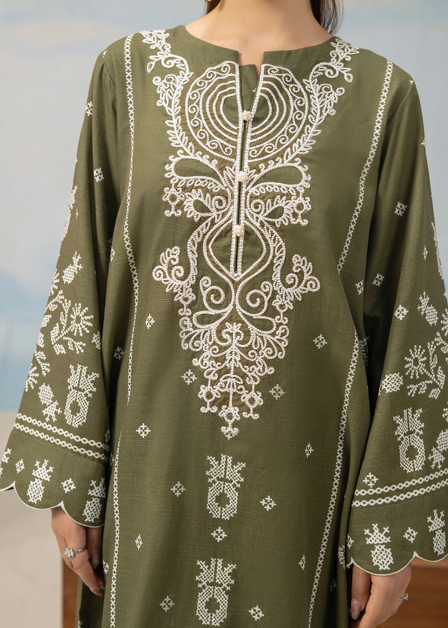 Olive green embroidered kurta back with vertical motif and wide patterned sleeve cuffs
