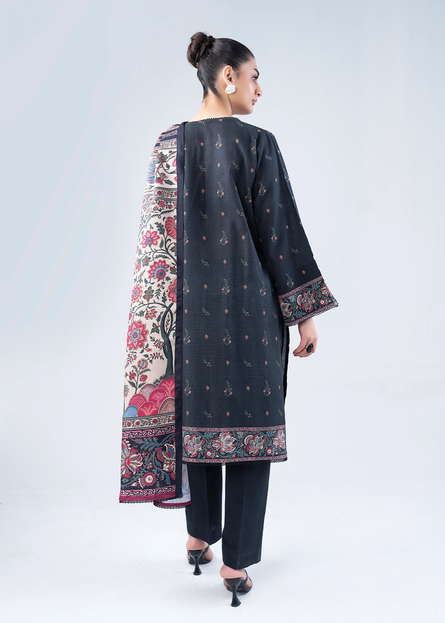 Women’s printed winter suit set, back view of dark kurta with floral border, pants
