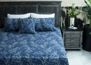 Navy cotton bed sheet on bed with white tree branch pattern