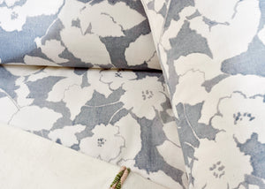 Close-up of blue and white floral cotton sateen duvet cover fabric with stitching