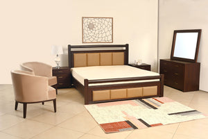 Dark wood bed with upholstered headboard, beige mattress, two side tables