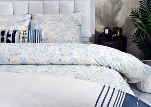 Cotton sateen duvet cover and pillow shams with light blue paisley and navy stripe edges