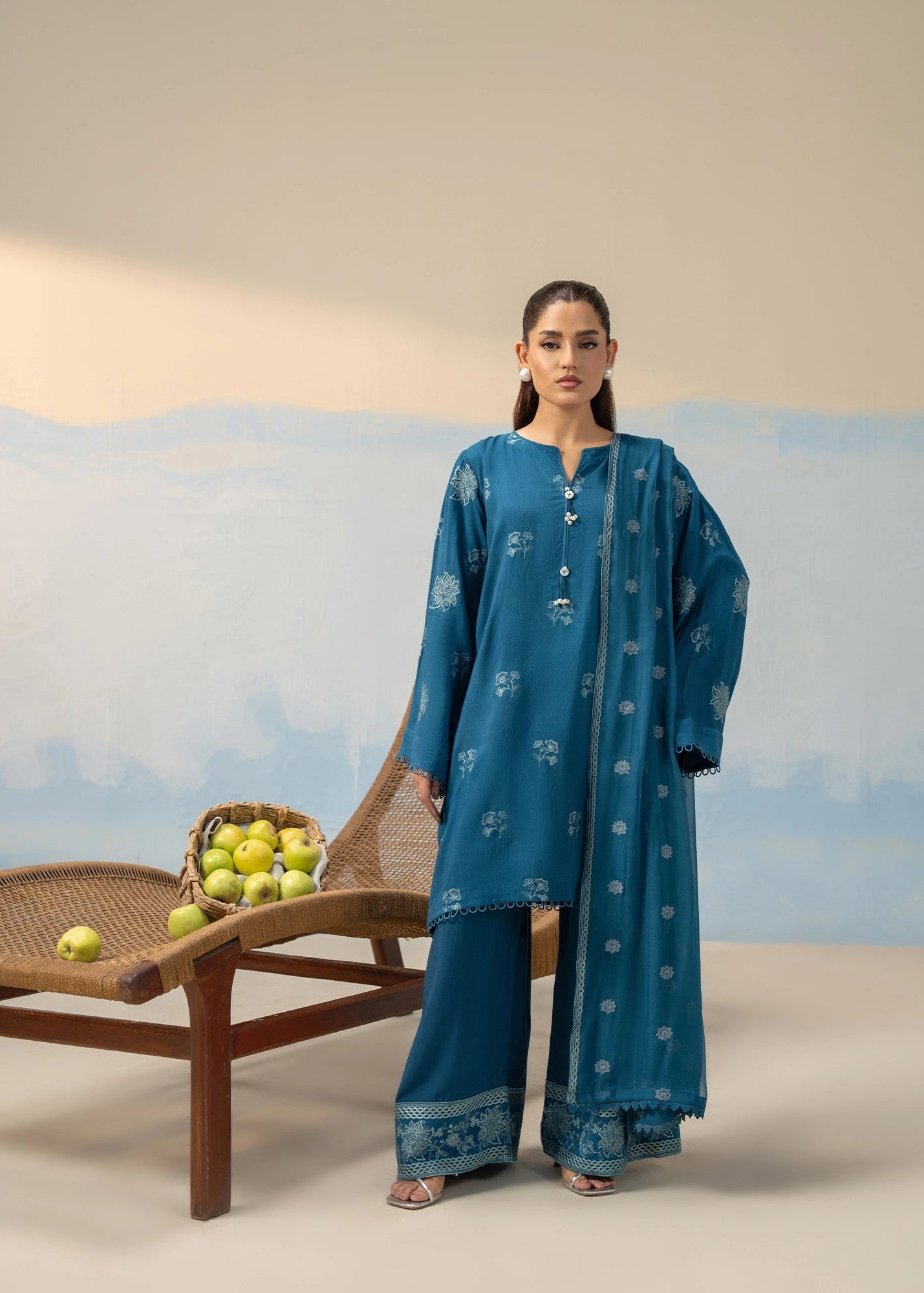 Women's blue embroidered 3-piece suit with long kurta, wide sleeves, and patterned pants