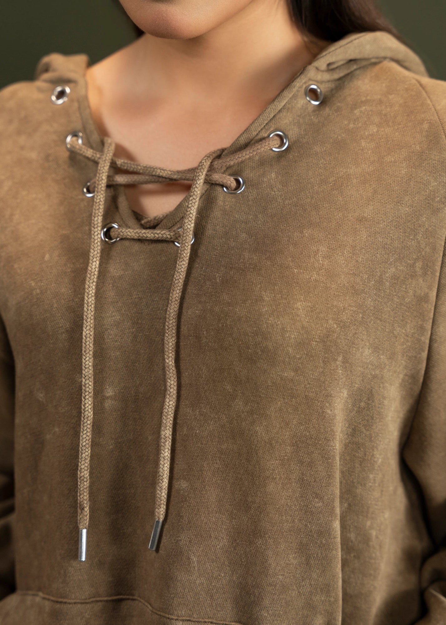 Men's brown terry casual trousers, close-up of waistband and upper leg seams.