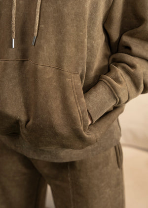 Men's brown terry casual trousers, close-up of front pocket and seam detail.