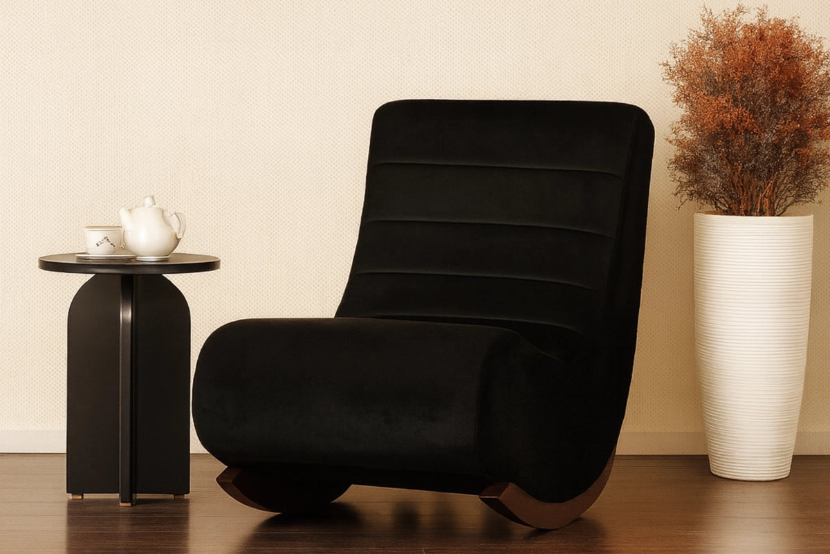 Black upholstered rocking chair with curved backrest and rocking base