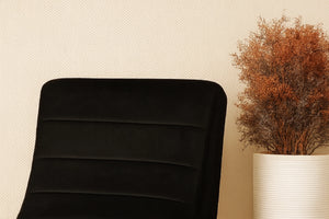 Black upholstered rocking chair with rounded backrest and padded seat