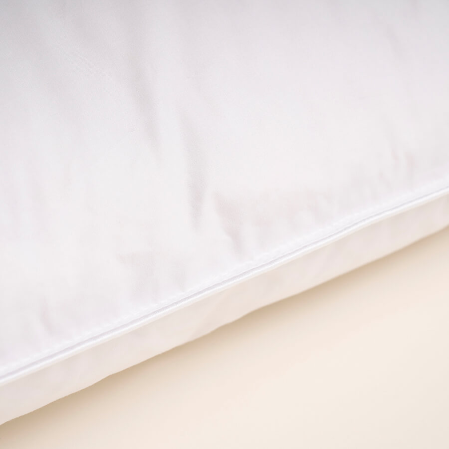 White pillow with smooth side panel and stitched edge