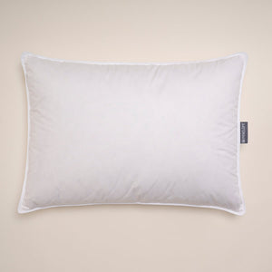 White rectangular down pillow with piping and side label