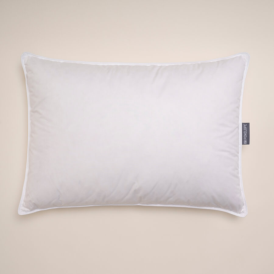 White rectangular down pillow with piping and side label