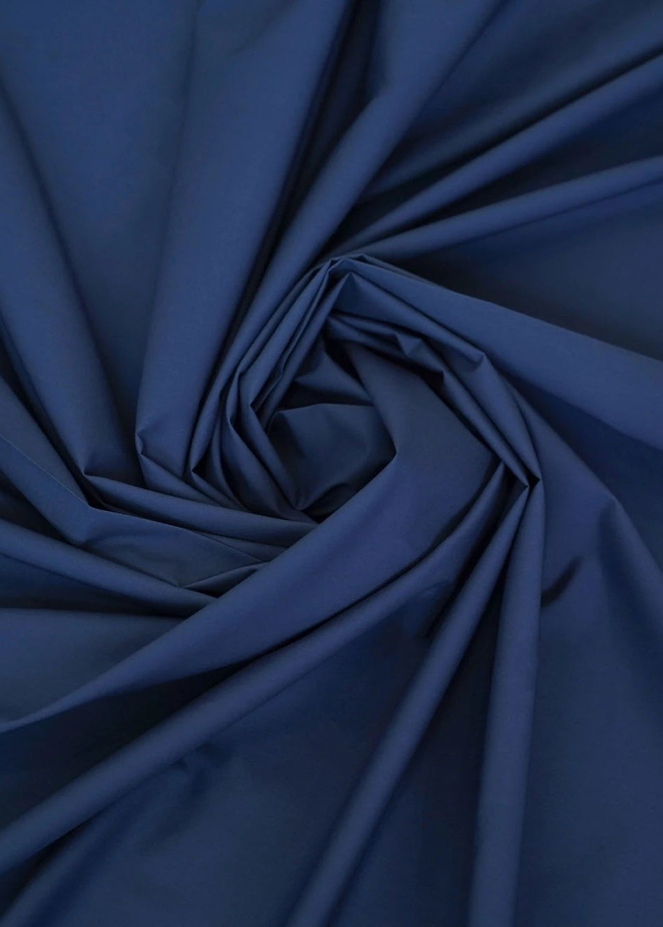 Navy wash-and-wear winter fabric, close-up with gathered fold texture