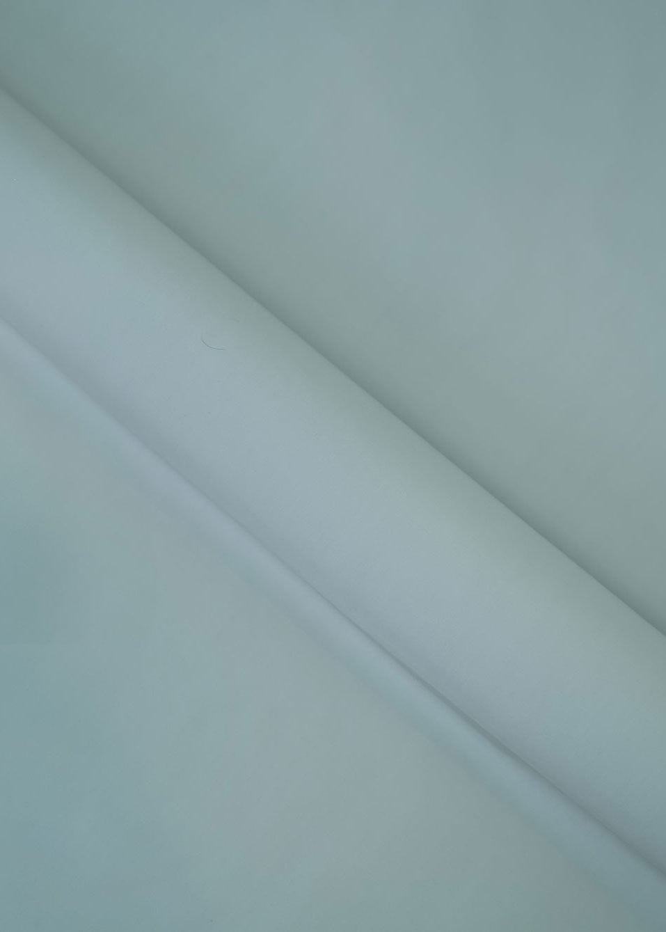 Icy blue fabric with long drape, smooth surface close-up
