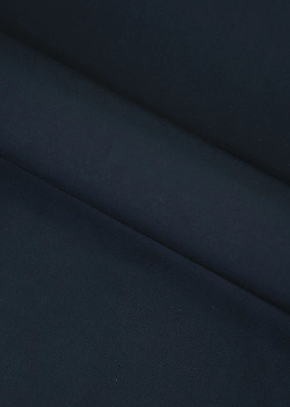 Dark black wash-and-wear fabric close-up with smooth drape