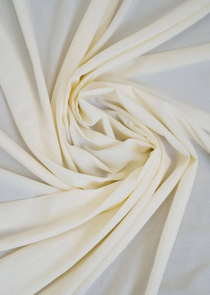 Oyster wash-and-wear fabric in light cream with visible folds and drape